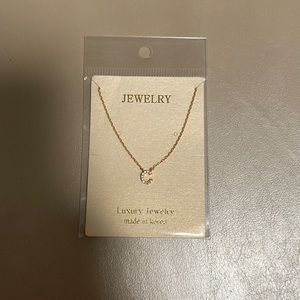 Gold C necklace brand new still in originally packaging